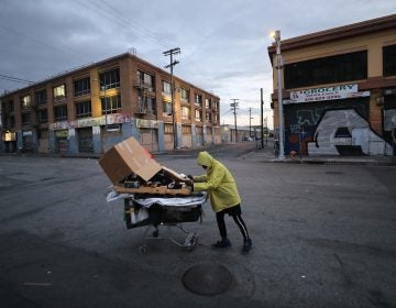 A homeless man pushes his belongings along a Los Angeles street. (Mario Tama/Getty Images)