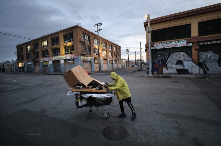 A homeless man pushes his belongings along a Los Angeles street. (Mario Tama/Getty Images)