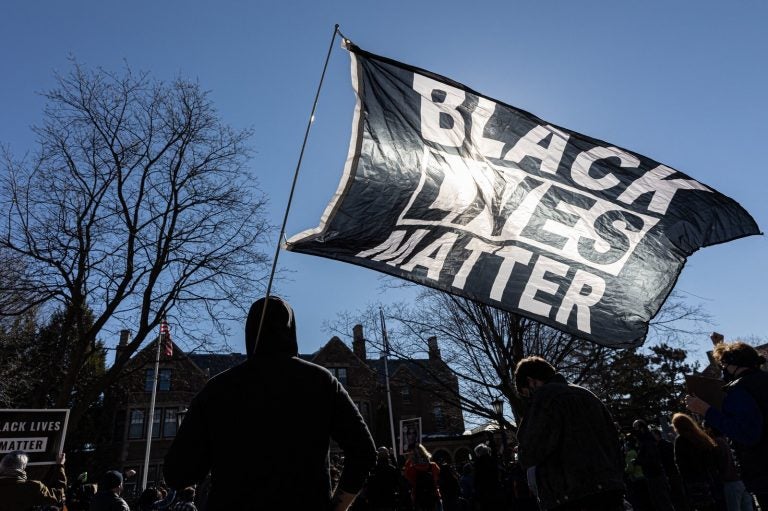 A man holds a Black Lives Matter flag during a protest