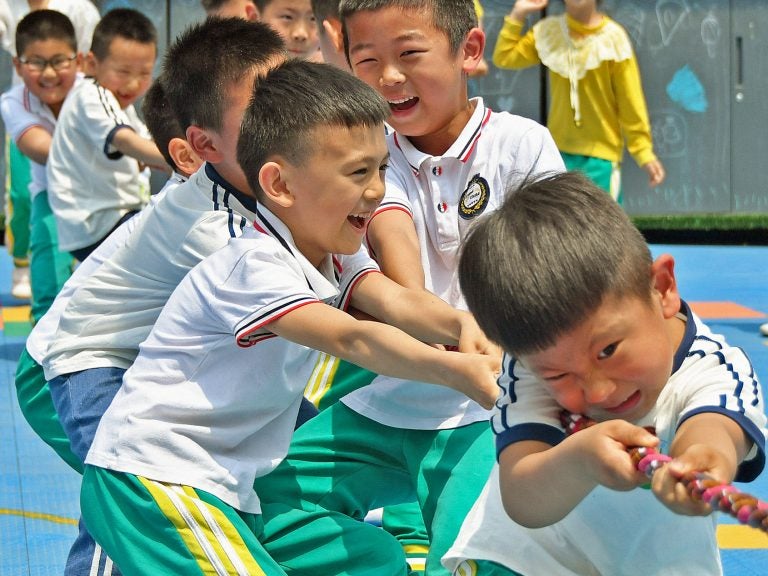 Allowing couples in China to have up to three children rather than two will help the country counteract a population that's shifting towards the elderly, the government says. (STR/AFP via Getty Images)