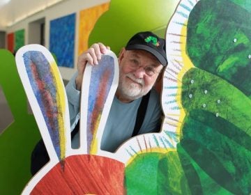 Amhurst  Ma .  09/27/2011 Eric Carle (cq)  is photographed at The Eric  Carle Museum of Picture Book Art. .He is in front of the  iconic image from  his childrens book The Very Hungry Caterpillar . Globe Staff/ Photographer Jonathan Wiggs :SECTION: Arts SLUG:  REPORTER: