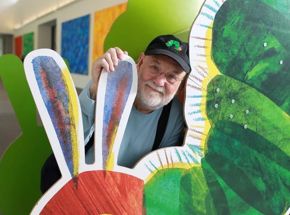 Amhurst  Ma .  09/27/2011 Eric Carle (cq)  is photographed at The Eric  Carle Museum of Picture Book Art. .He is in front of the  iconic image from  his childrens book The Very Hungry Caterpillar . Globe Staff/ Photographer Jonathan Wiggs :SECTION: Arts SLUG:  REPORTER: