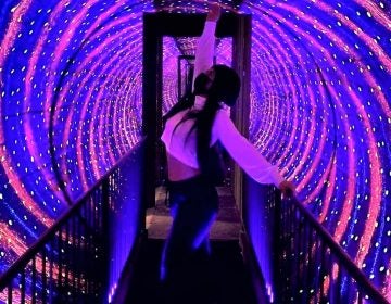 A Museum of Illusions visitor strikes a pose in the vortex tunnel