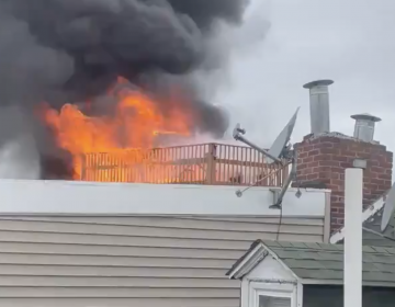 A fire is seen from the roof of a Northern Liberties home