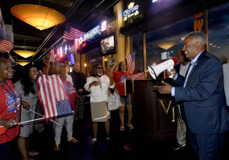 On June 8, interim Camden mayor and candidate Vic Carstarphen claims victory in the Democratic primary at Victor Pub in the city amid cheering supporters. (Photo by April Saul for WHYY)