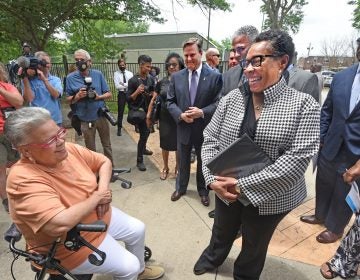 HUD Secretary Marsha Fudge chats with Ablett Village resident Maria Gonzalez at the announcement of the the CHOICE grant on June 2, 2021; to the left of Fudge are US Rep. Donald Norcross and interim Camden Mayor Vic Carstarphen. (Photo by April Saul for WHYY)