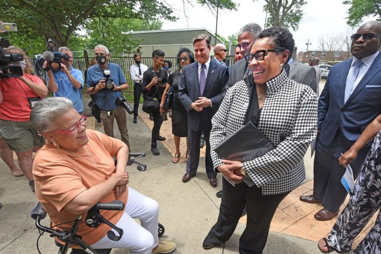 HUD Secretary Marsha Fudge chats with Ablett Village resident Maria Gonzalez at the announcement of the the CHOICE grant on June 2, 2021; to the left of Fudge are US Rep. Donald Norcross and interim Camden Mayor Vic Carstarphen. (Photo by April Saul for WHYY)
