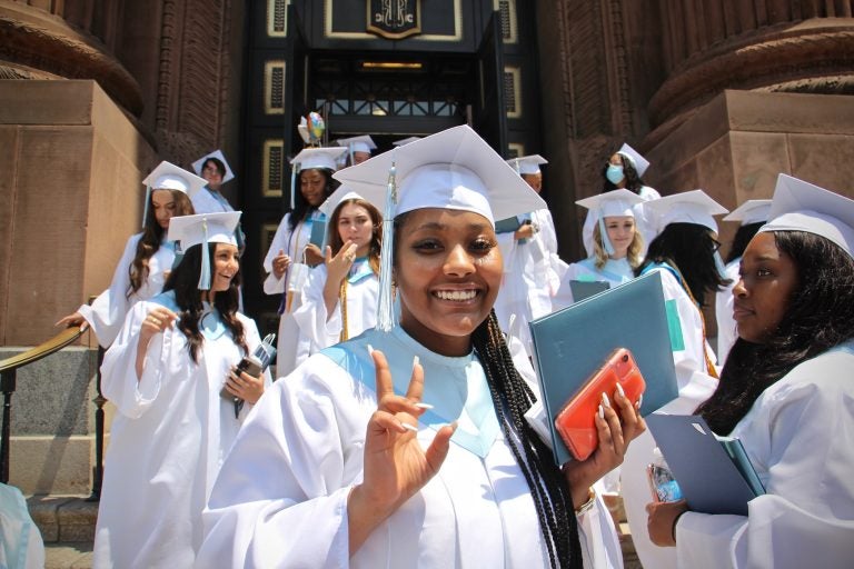 Members of John W. Hallahan Catholic Girls’ High School Class of '21, the school's last class, leave the Basilica of Saints Peter and Paul after their graduation ceremony. (Emma Lee/WHYY)