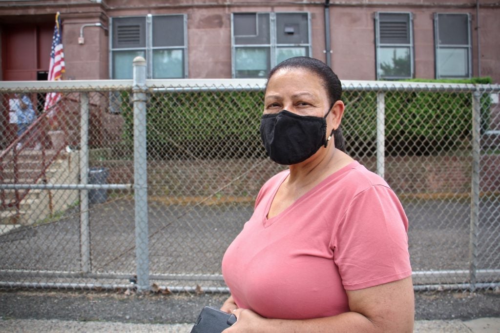 Altagracia De La Cruz wears a face mask outside