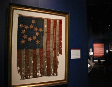 The oldest flag in the exhibit features 13 stars in a star pattern. It is one of the earliest American flags known to survive, made between 1800 and 1825, or possibly earlier. (Emma Lee/WHYY)