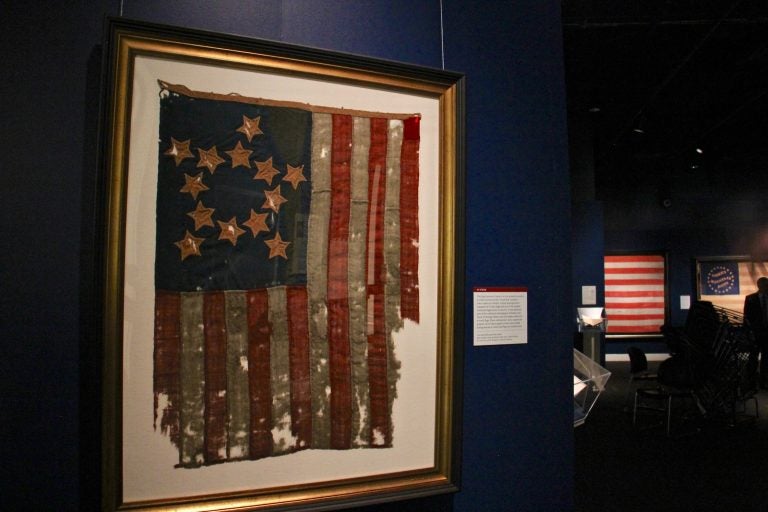 The oldest flag in the exhibit features 13 stars in a star pattern. It is one of the earliest American flags known to survive, made between 1800 and 1825, or possibly earlier. (Emma Lee/WHYY)