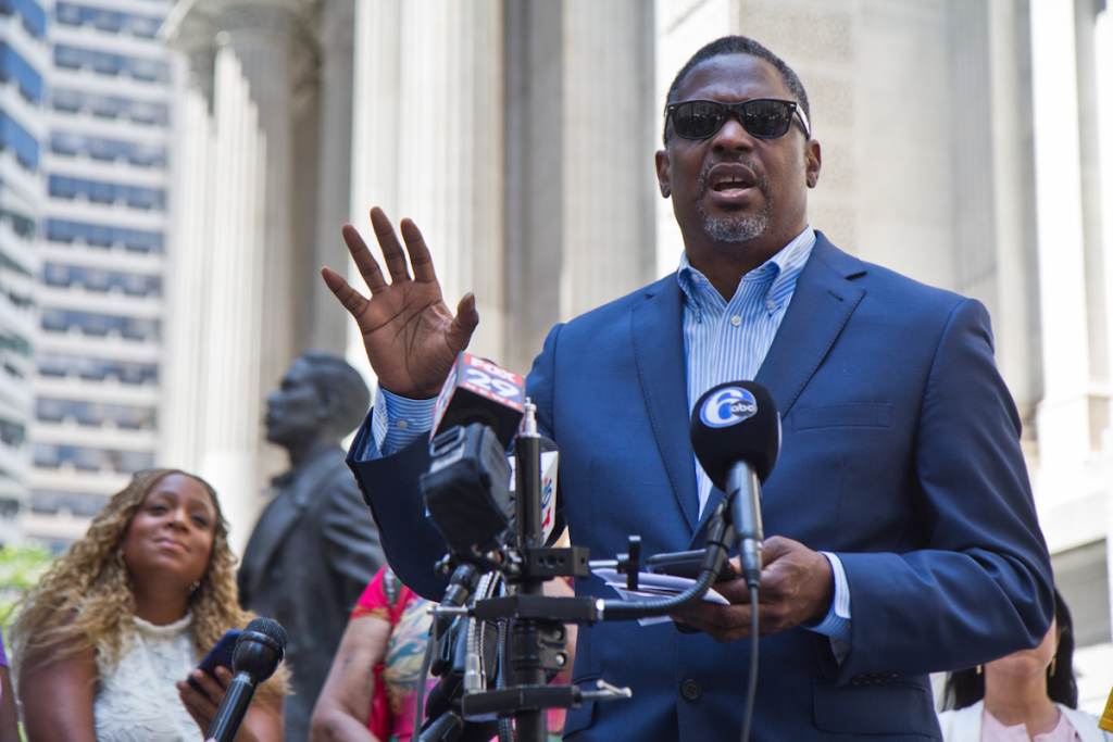 Reverend Gregory Holsten addresses the media at a press conference