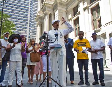 Rev. Robert Collier addresses the media at a press conference