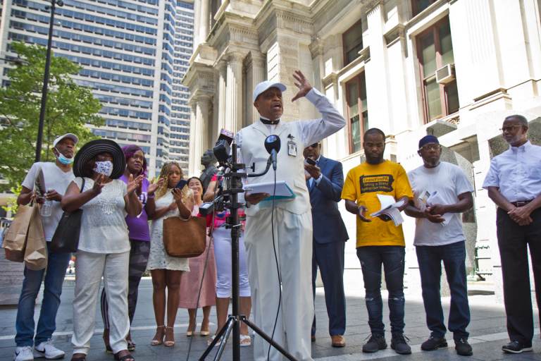 Rev. Robert Collier addresses the media at a press conference