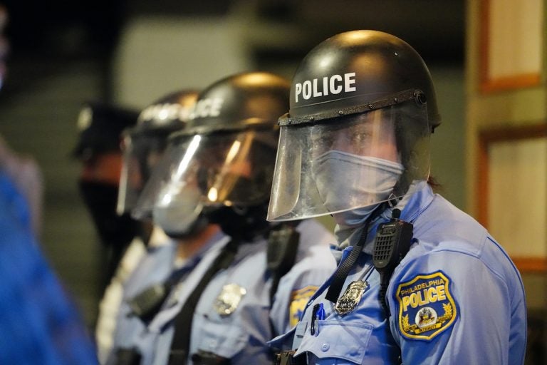 Philadelphia police stand in position during a march by protesters Tuesday Oct. 27, 2020 in Philadelphia. Hundreds of demonstrators marched in West Philadelphia over the death of Walter Wallace, a Black man who was killed by police in Philadelphia. (AP Photo/Matt Slocum)