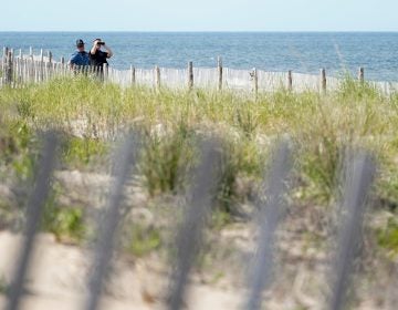 Law enforcement officers guard the beach as they wait for Marine One, with President Joe Biden on board, to land at Rehoboth Beach, Del., Wednesday, June 2, 2021. Biden is spending a few days at his home in Rehoboth Beach to celebrate first lady Jill Biden's 70th birthday. (AP Photo/Susan Walsh)