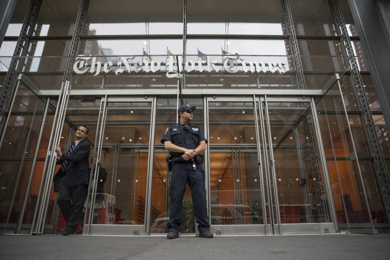 FILE - In this June 28, 2018, file photo, a police officer stands outside The New York Times building in New York. The Trump Justice Department secretly obtained the phone records of four New York Times journalists as part of a leak investigation, the newspaper said Wednesday, June 2, 2021. (AP Photo/Mary Altaffer, File)