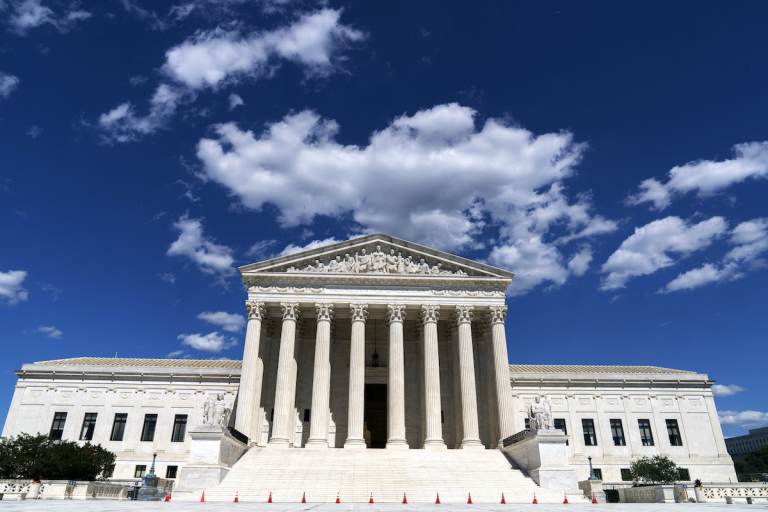 A view of the exterior of the U.S. Supreme Court building on a sunny day.