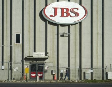 A worker walks into a JBS meat packing plant