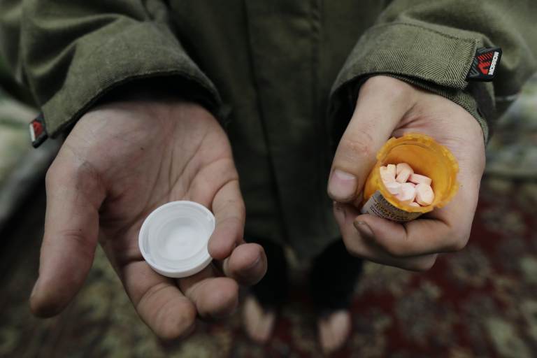 Jon Combes holds his bottle of buprenorphine