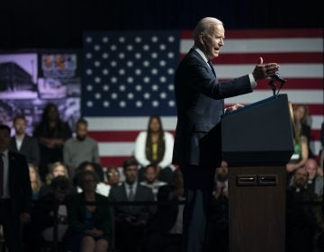 President Joe Biden gestures while speaking from behind a podium