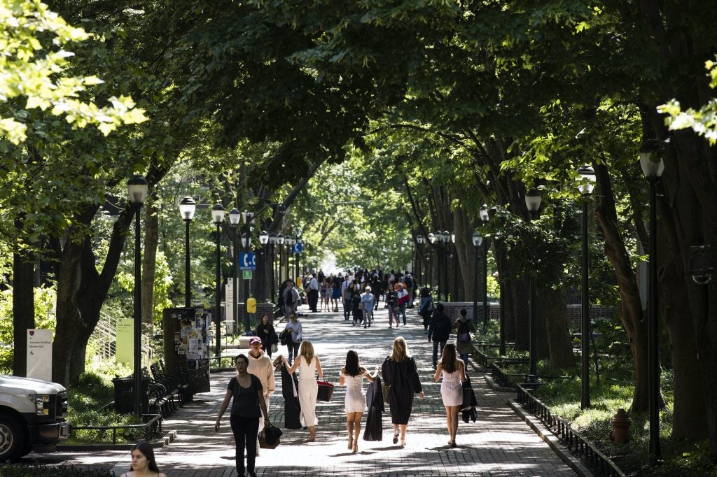 People walk along University of Pennsylvania's campus in the spring