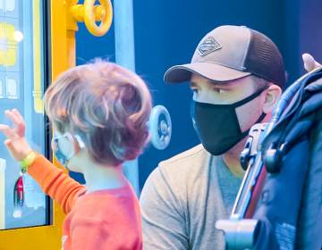 A father and son looking at an interactive screen at the Franklin Institute in Philadelphia