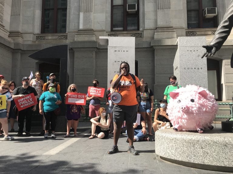 Shane Riggins, of Philadelphia Socialist Alternative, leads a protest by the group Tax The Rich PHL against proposed business tax cuts in the Philadelphia 2022 municipal budget. (Laura Benshoff/WHYY)