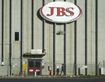 A worker heads into JBS meatpacking plant in Greeley, Colo.  A ransomware attack on the world's largest meat company is disrupting production around the world just weeks after a similar incident shut down a U.S. oil pipeline.  (AP Photo/David Zalubowski)