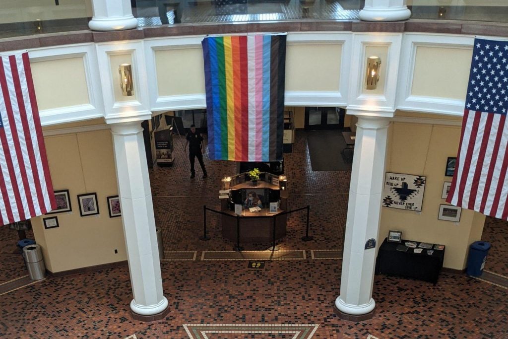 An LGBTQ pride flag hanging inside the Capitol’s East Wing Rotunda