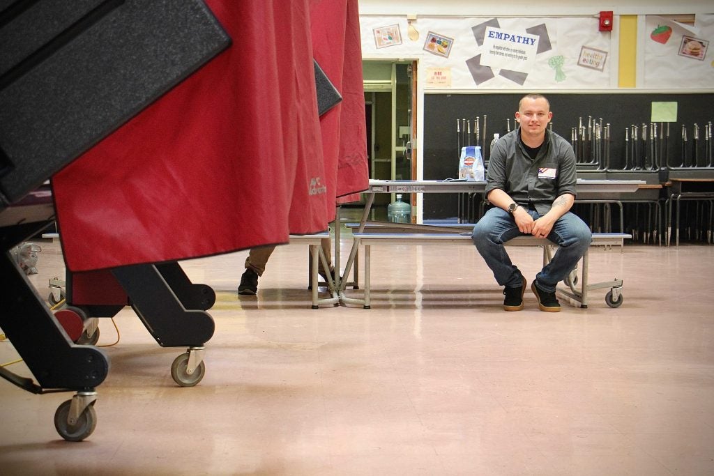 National Guardsman Tim Rzemyk helps out at a polling place