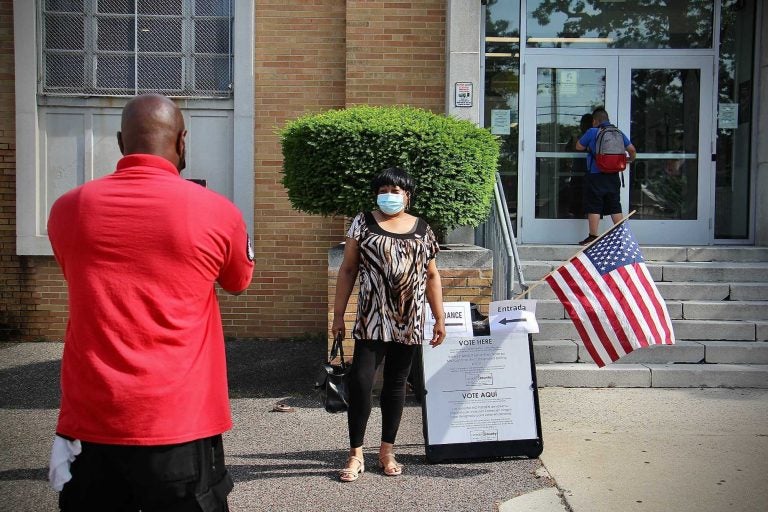 Tanya Ross poses for a picture outside a polling place