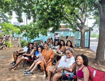 Reyhauna Yates (center) and her family listen to the Sistah Soul performances