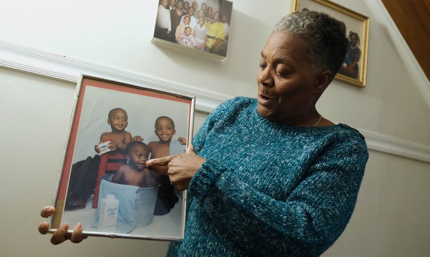 Joanne Henderson points to a picture of her son, Shakoor, as a baby. (Photo by Matt Smith)