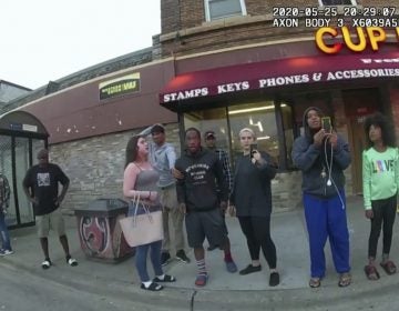 A police body camera image shows bystanders including Darnella Frazier (third from right filming) as former Minneapolis police officer Derek Chauvin was recorded pressing his knee on George Floyd's neck in Minneapolis. (Minneapolis Police Department via AP)