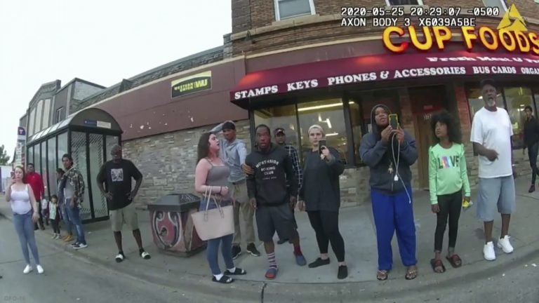 A police body camera image shows bystanders including Darnella Frazier (third from right filming) as former Minneapolis police officer Derek Chauvin was recorded pressing his knee on George Floyd's neck in Minneapolis. (Minneapolis Police Department via AP)
