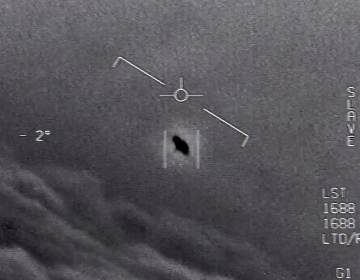 In an image from video footage from 2015, an unexplained object is seen at center as it soars among the clouds, traveling against the wind. 