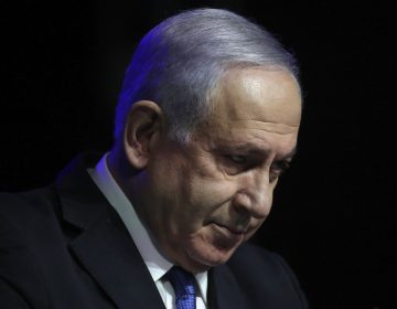 Israeli Prime Minister Benjamin Netanyahu tilts his head down