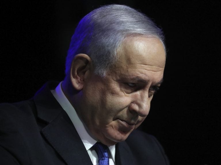 Israeli Prime Minister Benjamin Netanyahu tilts his head down