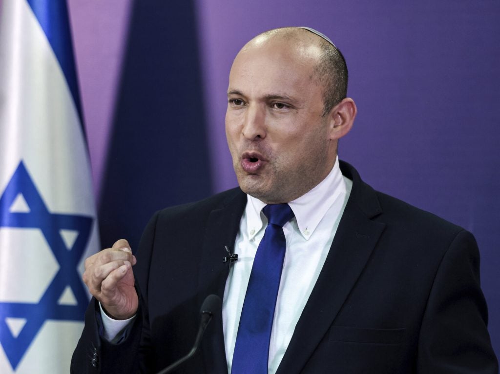 Naftali Bennett gestures while speaking