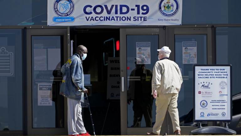 A COVID-19 vaccination clinic last month in Auburn, Maine. A drop in life expectancy in the U.S. stems largely from the coronavirus pandemic, a new study says. (Robert F. Bukaty/AP)