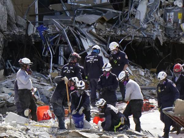 Crews work in the rubble at the Champlain Towers South Condo