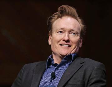 Television host Conan O'Brien smiles towards the audience at Sanders Theatre on the campus of Harvard University in Cambridge, Friday, Feb. 12, 2016.  O'Brien, who graduated from the school in 1985, shared a conversation with Harvard President Drew Faust and an audience of guests. (AP Photo/Charles Krupa)