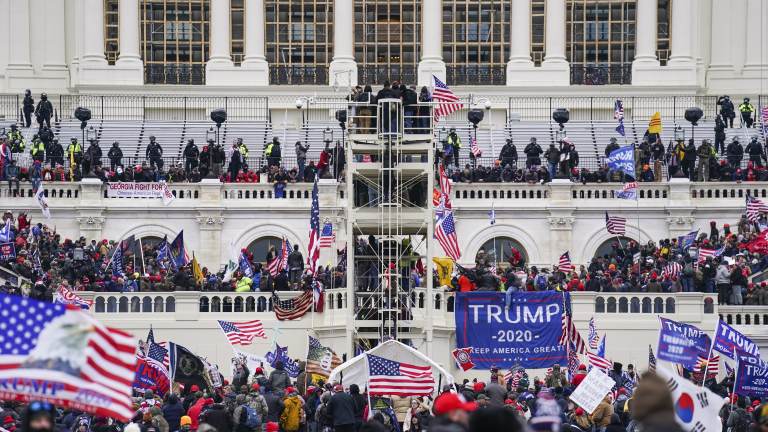 File photo: Insurrectionists loyal to former President Donald Trump breach the U.S. Capitol in Washington on Jan. 6.  (John Minchillo/AP)