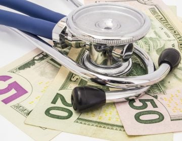 Save Download Preview Stethoscope lying on the money
