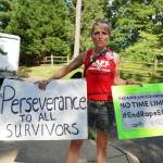 A protester outside Bill Cosby's Elkins Park, Pa., home holds a sign that reads, 