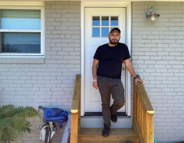 Jonathan Caballero stands on his front porch