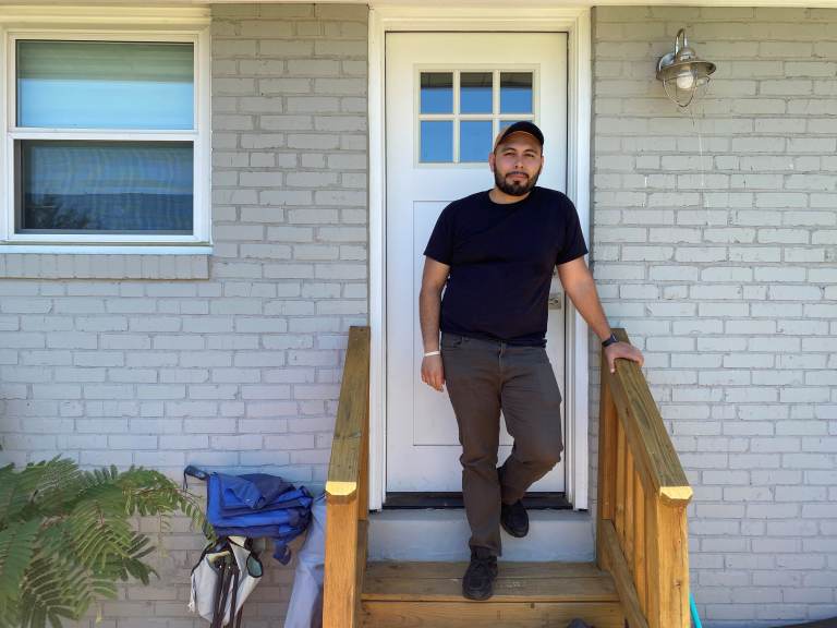 Jonathan Caballero stands on his front porch