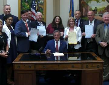 Delaware Gov. John Carney signs several budget bills surrounded by legislative leaders in his Dover office Wednesday afternoon. (courtesy Gov. Carney's office)