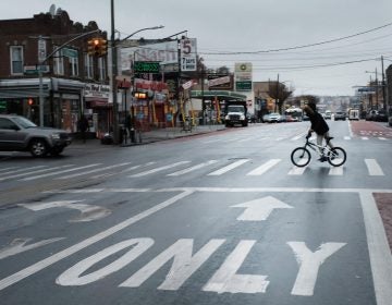 A person rides a bike across a New York street